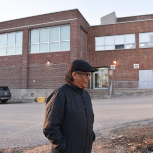 man in front of building