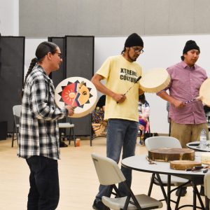 men chanting with tambourines